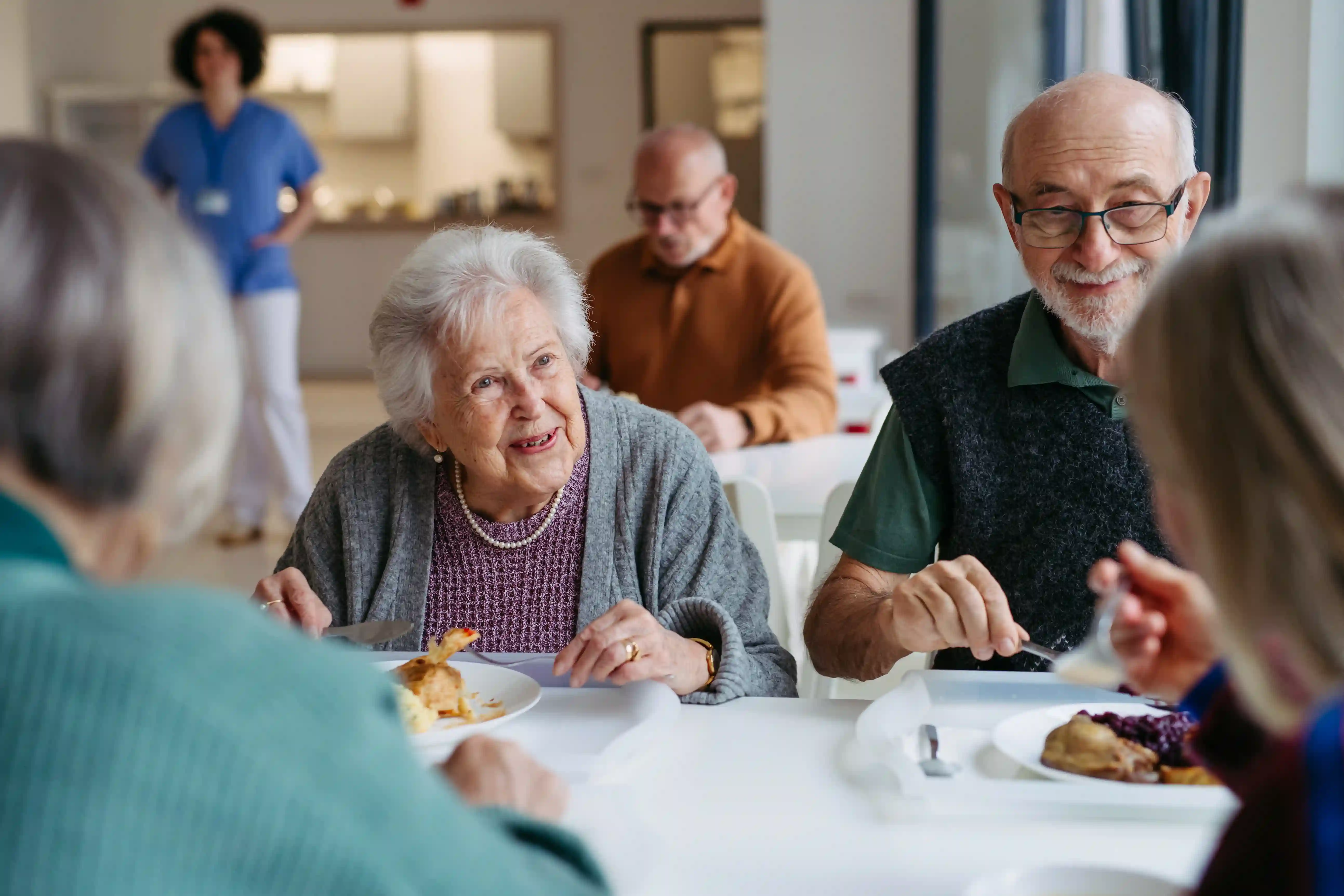 Residents enjoying a home-cooked meal together at Joani Twin Lakes Adult Family Home